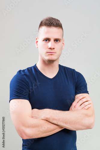 Studio shot image of young sporty man who is ready for workout.