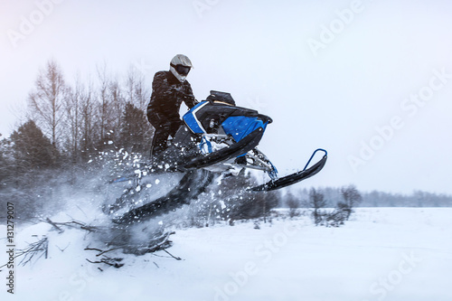 Sportsman jump on a snowmobile