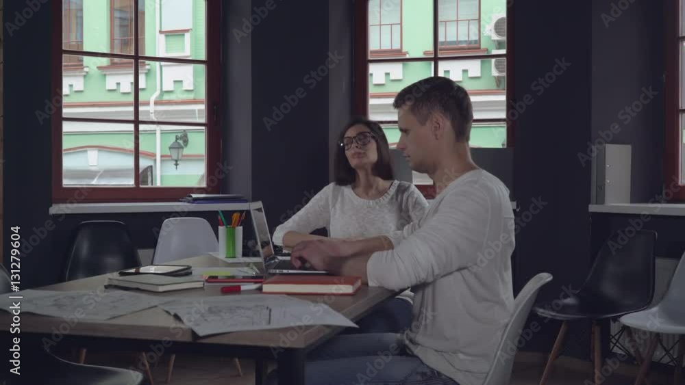 young businesswoman and handsome businessman finished the working day at the casual office. Tired business team closed laptop and have a break. Employees casual woman and man using computer at work young businesswoman and handsome businessman finished the working day at the casual office. Tired business team closed laptop and have a break. Employees casual woman and man using computer at work