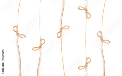 lines flaxen ropes with bows and knots on a white background