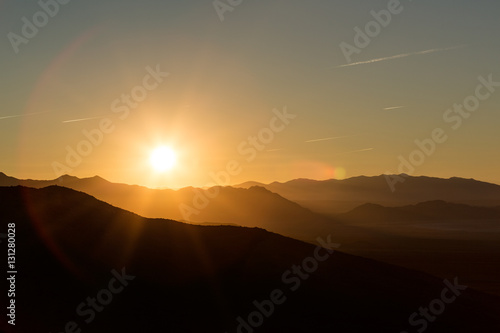 Backlit mountains and plains with a beautiful sunrise