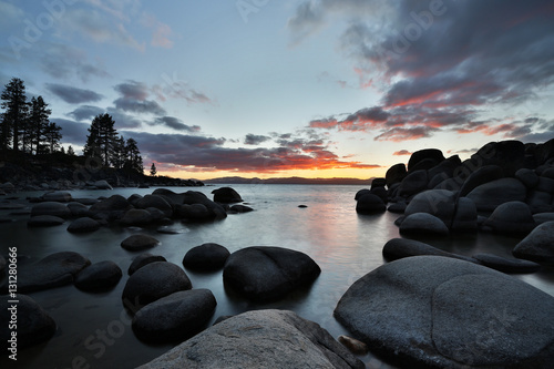Sunset at a rocky beach at the lake. Long exposure.