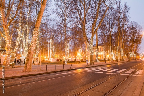 Cars passing Zrinjevac park in Zagreb Croatia during Advent, blue light trail, motion blur 