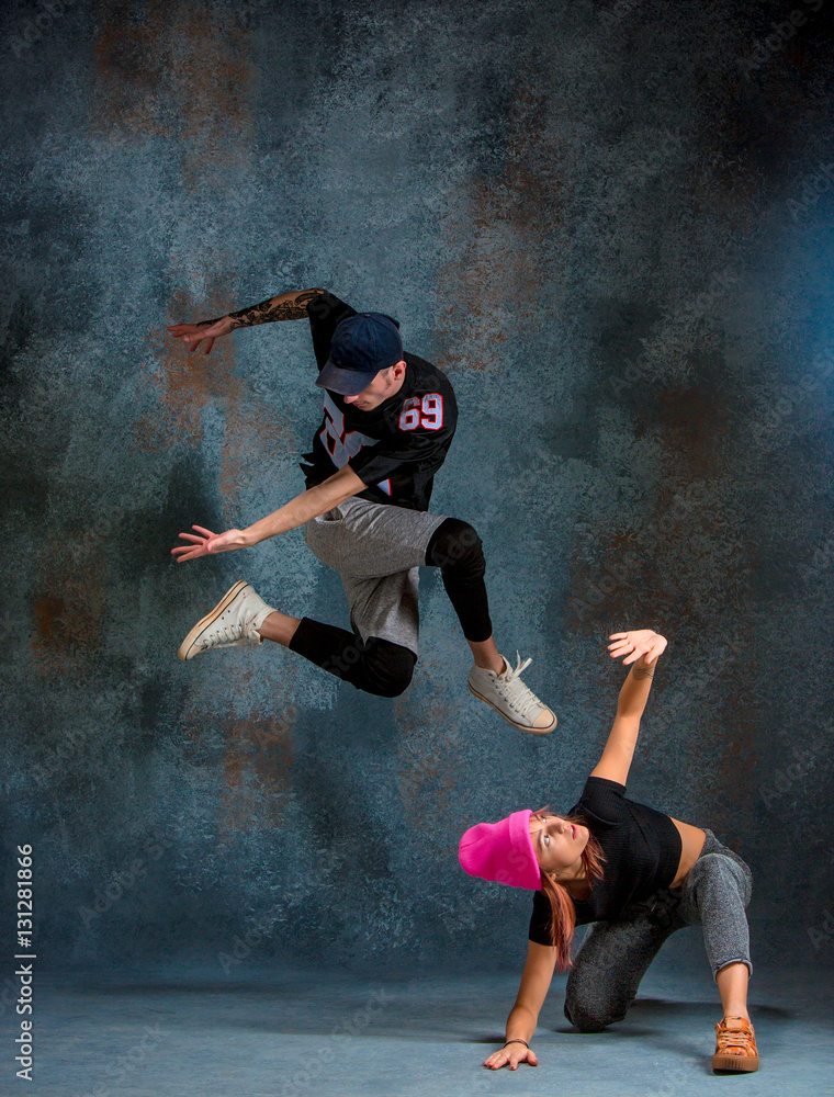 The two young girl and boy dancing hip hop in the studio