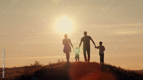 happy family at sunset silhouette of the water