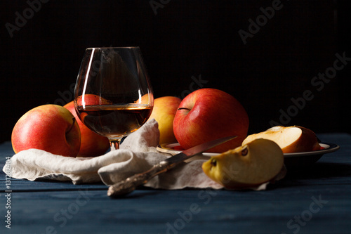 glass of Calvados Brandy and red apples photo