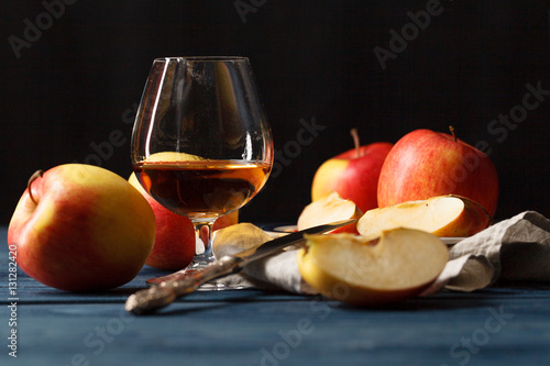 glasse of Calvados Brandy and red apples photo