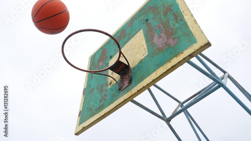 old basketball hoop bottom view outdoors sport rusty iron ball enters the basket