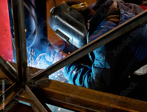 Semi-automatic welding of metal structures in the shop photo