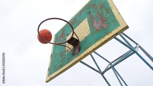 old basketball hoop bottom view outdoors sport rusty iron ball enters the basket