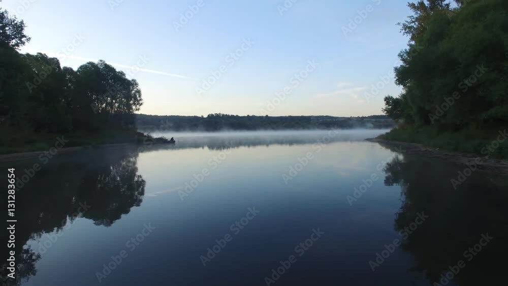Aerial view at river in morning time. Fisherman on the shore. Aerial view at river in morning time. Fisherman on the shore.
