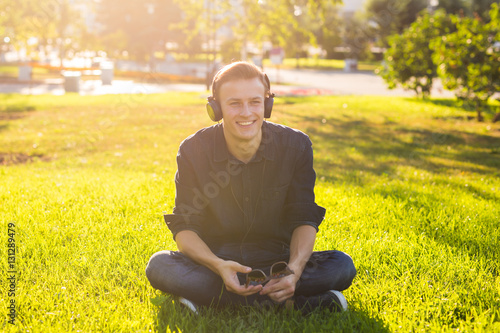 Young man in the park listen to the music