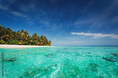 tropical beach against blue sky, vacation concept