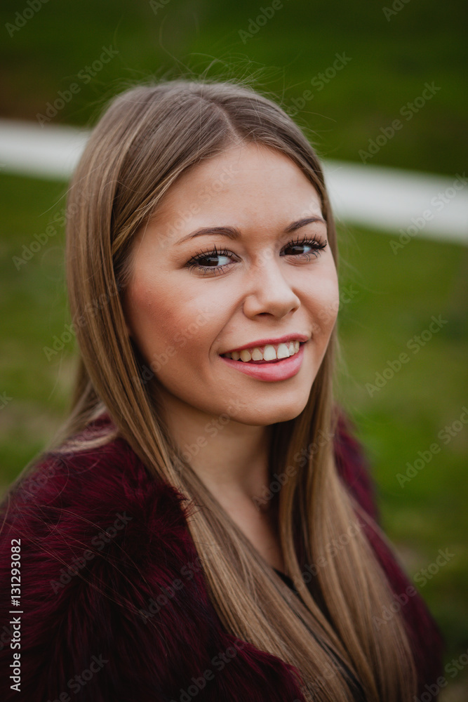 Pretty blonde girl with fur coat