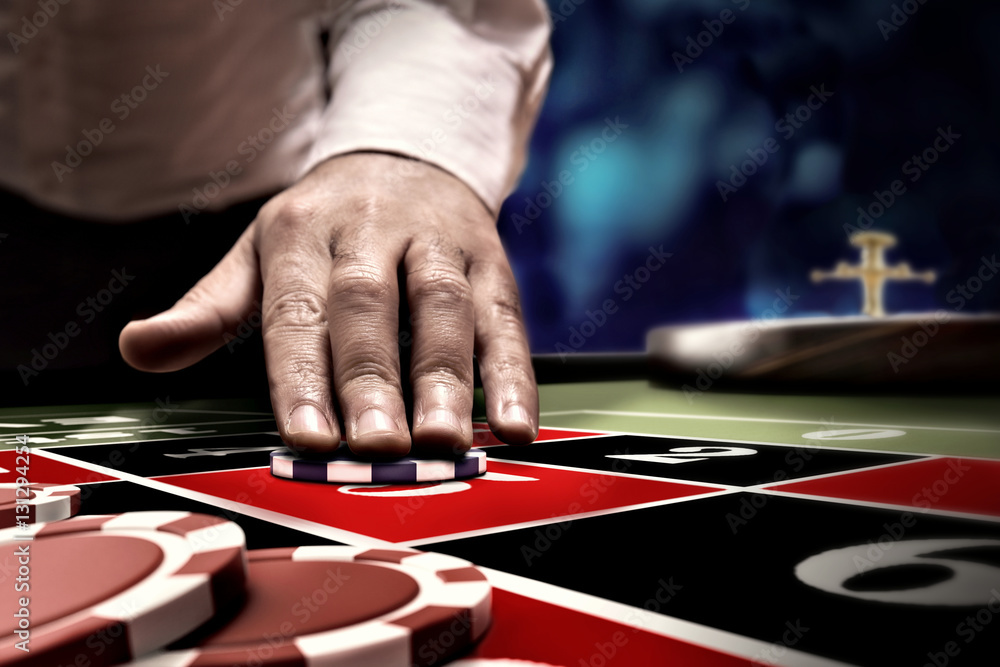 gambler bet on roulette at casino table gambler bet on roulette at casino table