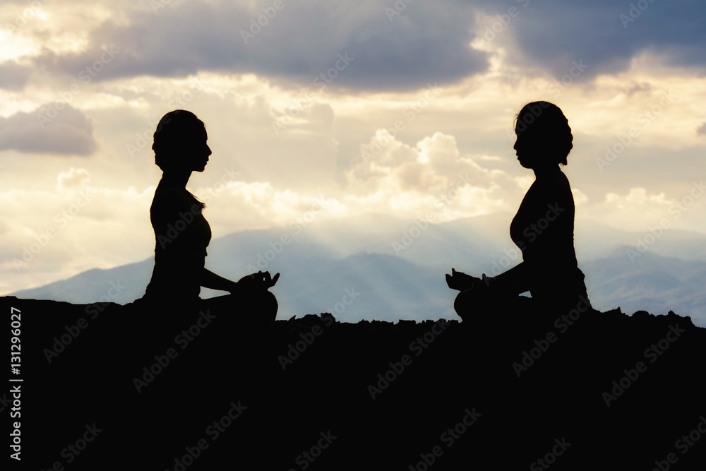 Silhouette young girl doing yoga fitness exercise outdoor in beautiful mountains landscape. Silhouette young girl doing yoga fitness exercise outdoor in beautiful mountains landscape.