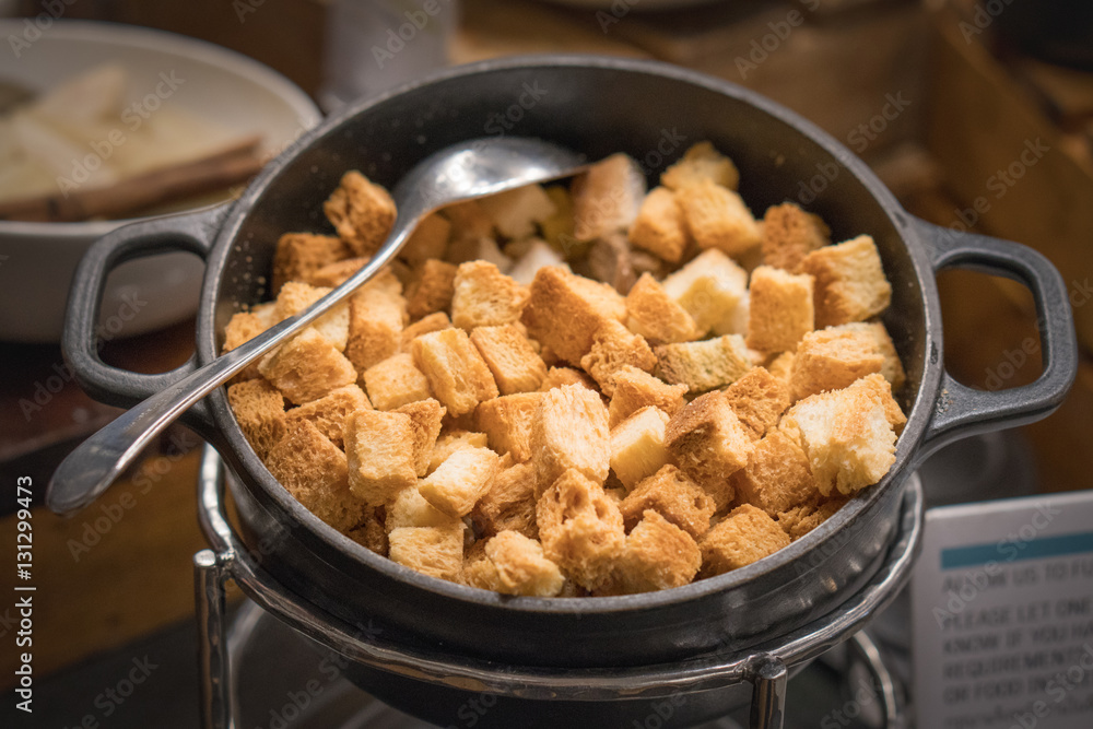 Bread baked in a black bowl and spoon Bread baked in a black bowl and spoon