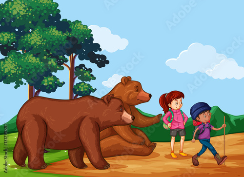 People hiking up the mountain with two bears