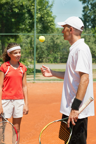 Tennis training. Tennis instructor and teenage student photo