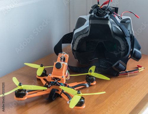 Small racer drone with first person view wireless goggles