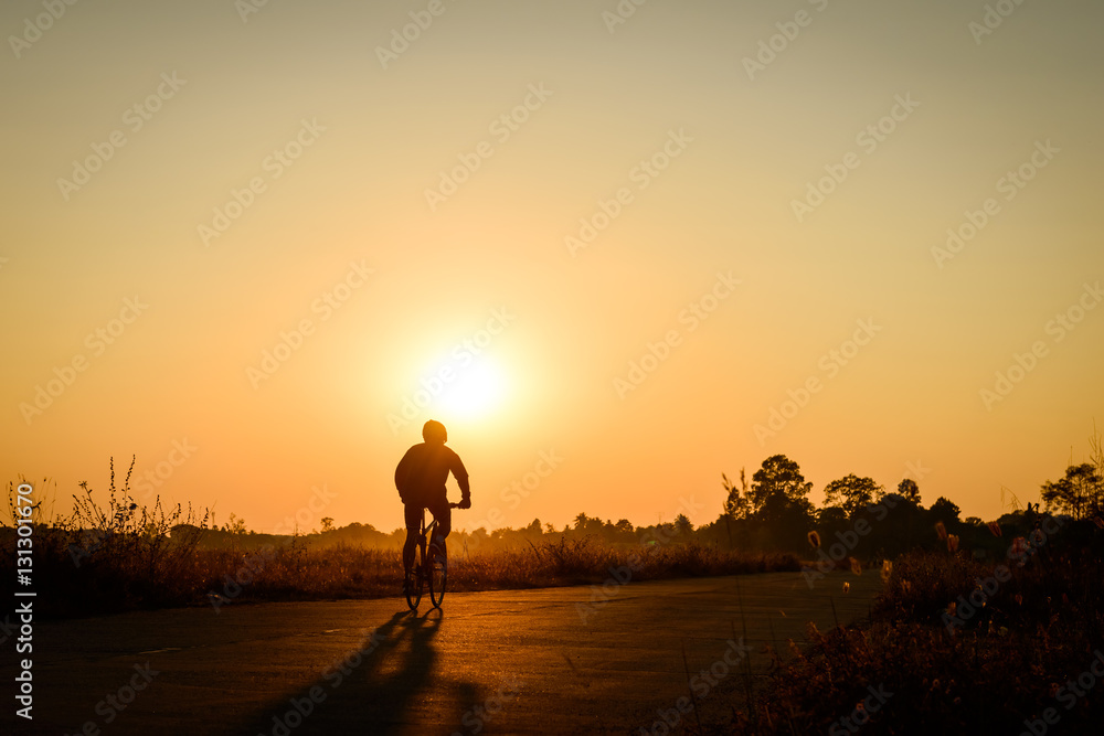 Silhouette of cyclist on sunset background Silhouette of cyclist on sunset background