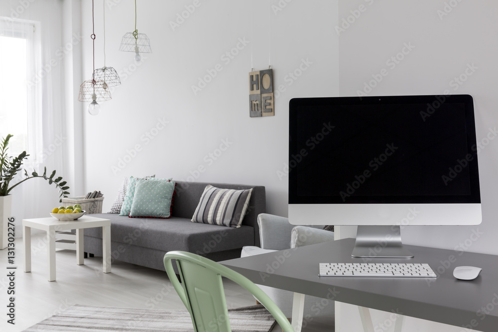 Grey desk with computer in modern living room Grey desk with computer in modern living room