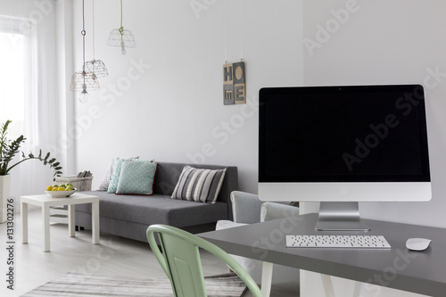 Grey desk with computer in modern living room