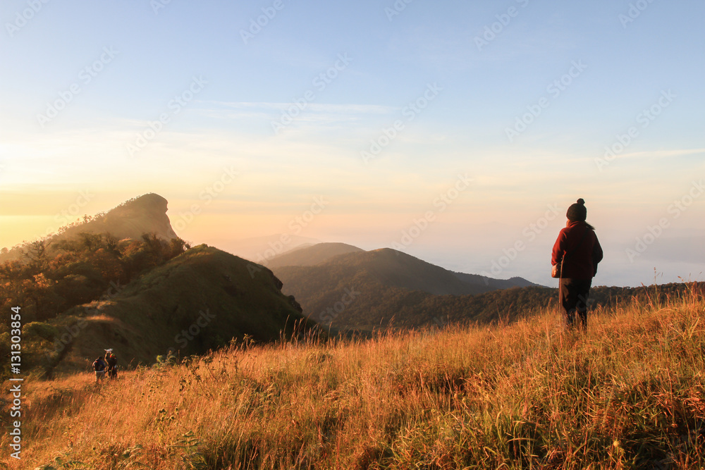 Young girl see mountain view in sunset