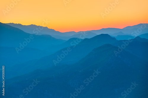 Landscape with blue mountains at sunset © muratart