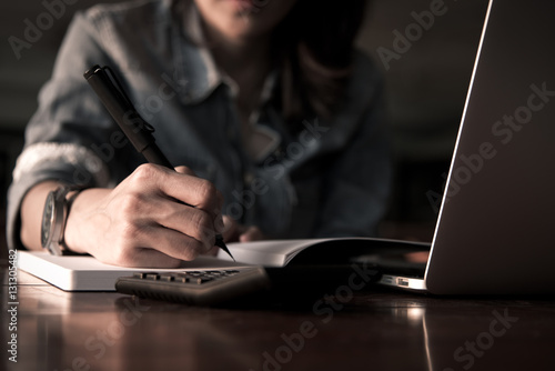 Wallpaper Mural People writng on notebook and work with calculator and laptop on wooden table Torontodigital.ca