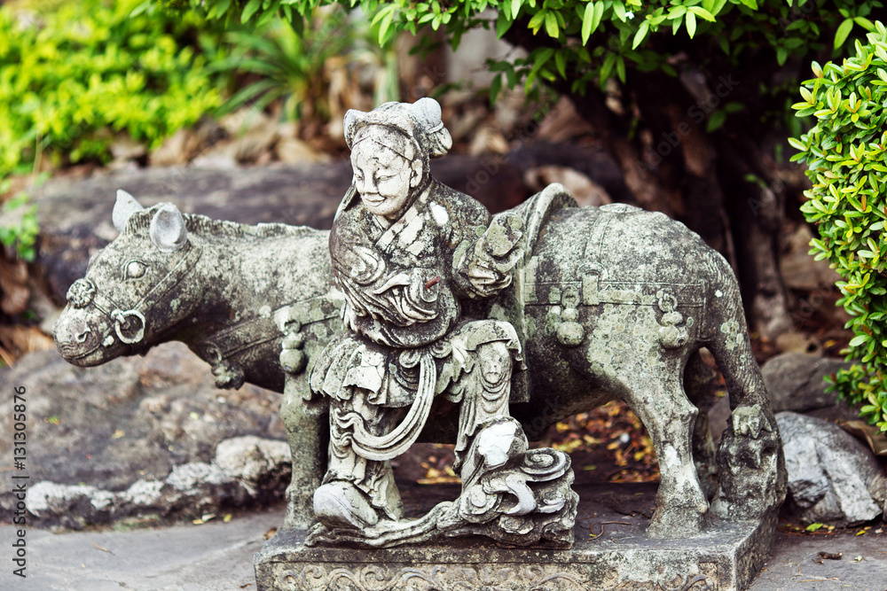 Stone statue of woman and horse in Thailand