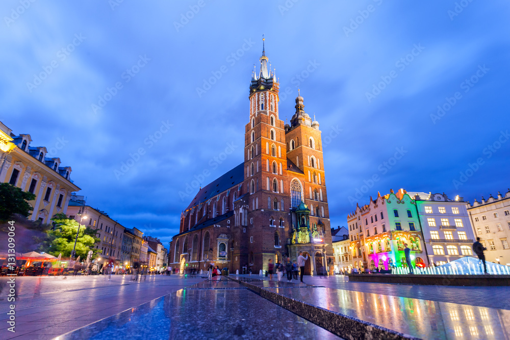 St. Mary's Church at night. Market Square - main square in old city. Krakow Poland.
