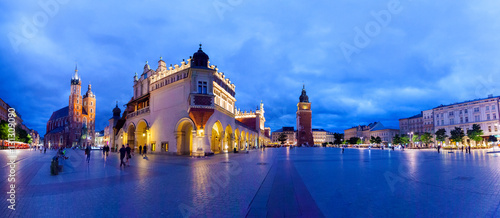 Cloth Hall well known as sukiennice, St. Mary's Church and the Clock Tower at night. Panoramic view of Market Square - main square in old city. Krakow Poland.