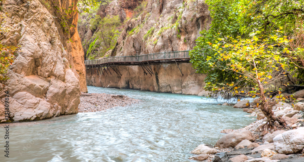 Fototapeta premium Mountain stream full of smooth rocks in Saklikent Gorge Canyon in Turkey