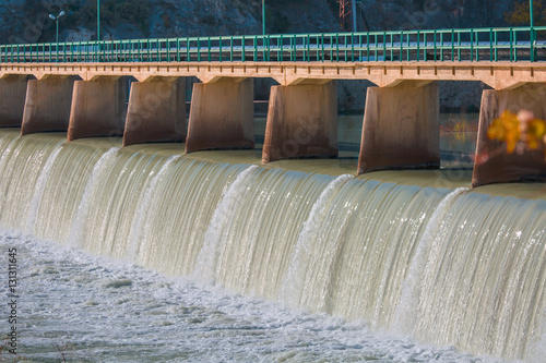 фотографія Strong stream of water at the hydroelectric dam