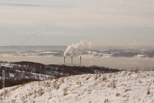 Smokestacks spew Pollution Carbon dioxide in the atmosphere