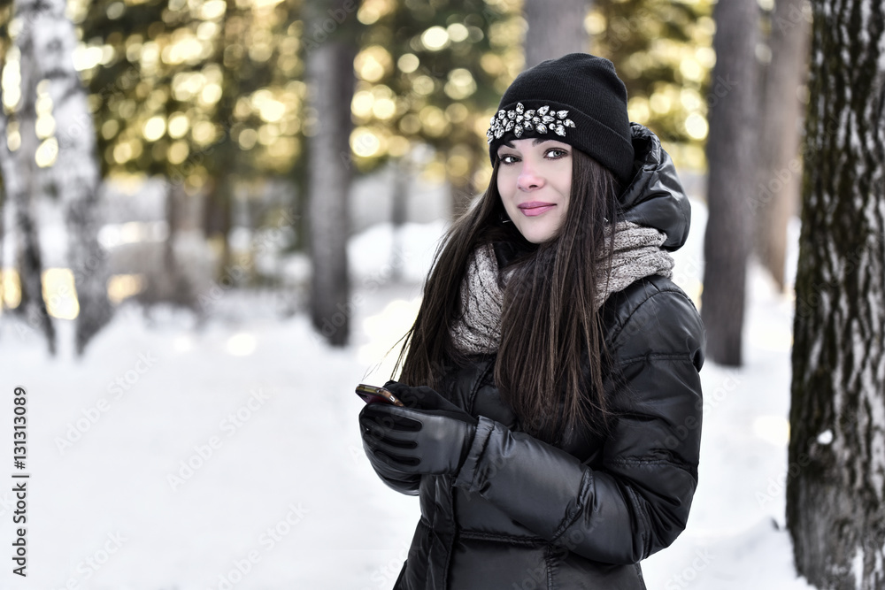 Girl in winter park dials the phone number Girl in winter park dials the phone number