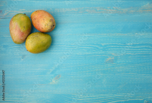 Lot of mango on a blue wooden background