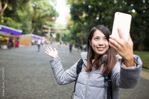 Woman take self photo at Japanese temple