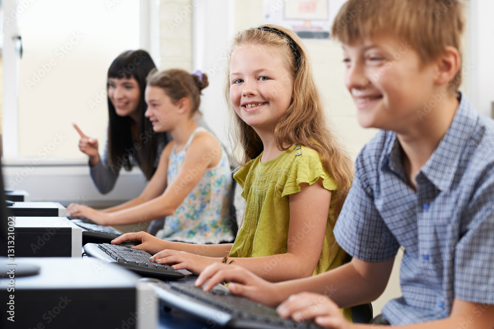 Female Elementary Pupil In Computer Class With Teacher Female Elementary Pupil In Computer Class With Teacher