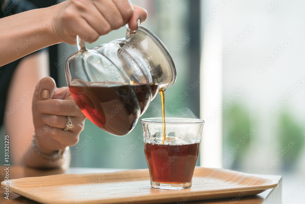 The hand with spoon and cup of tea
