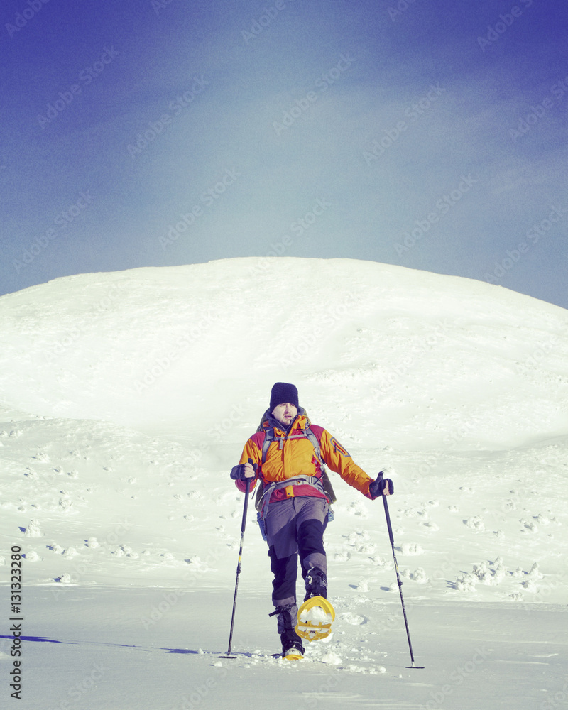 Winter hiking in the mountains on snowshoes with a backpack and Winter hiking in the mountains on snowshoes with a backpack and