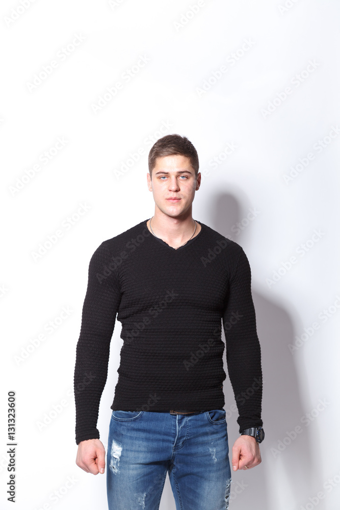 Fototapeta premium Confident and stylish. Cheerful young man looking at camera while standing against white background