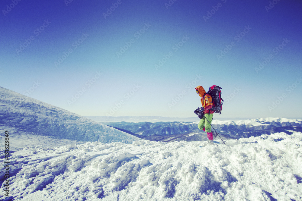 Winter hiking in the mountains on snowshoes with a backpack and Winter hiking in the mountains on snowshoes with a backpack and
