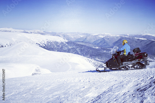 Man driving snowmobile.