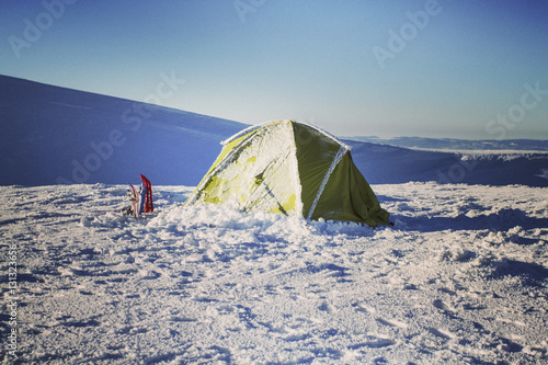 Winter hiking in the mountains on snowshoes with a backpack and