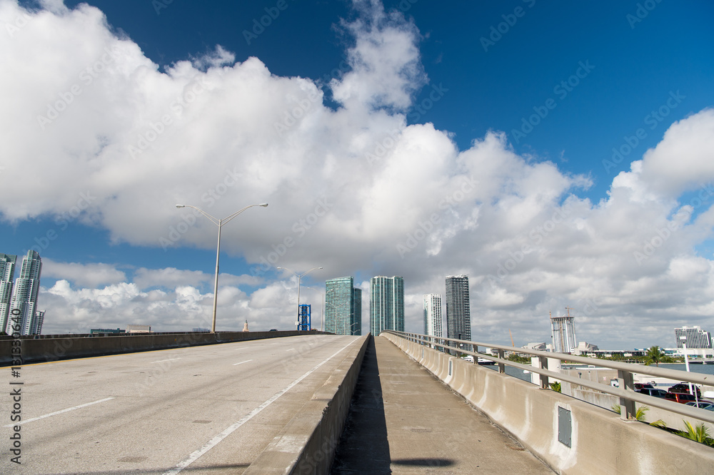 highway with skyscrapers on sky