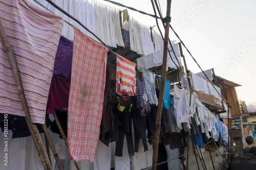 india mumbai slum people and children working and living laundry, plasitic   © henktennapel