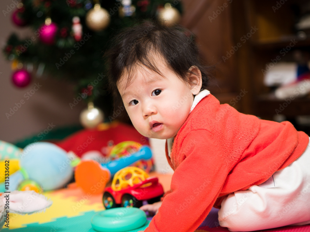 Obraz premium Asian baby girl playing toy in home