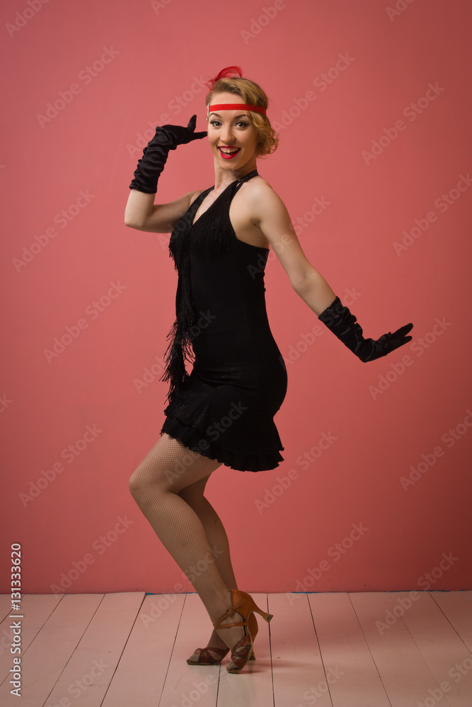 Pretty actress in black retro dress dancing charleston